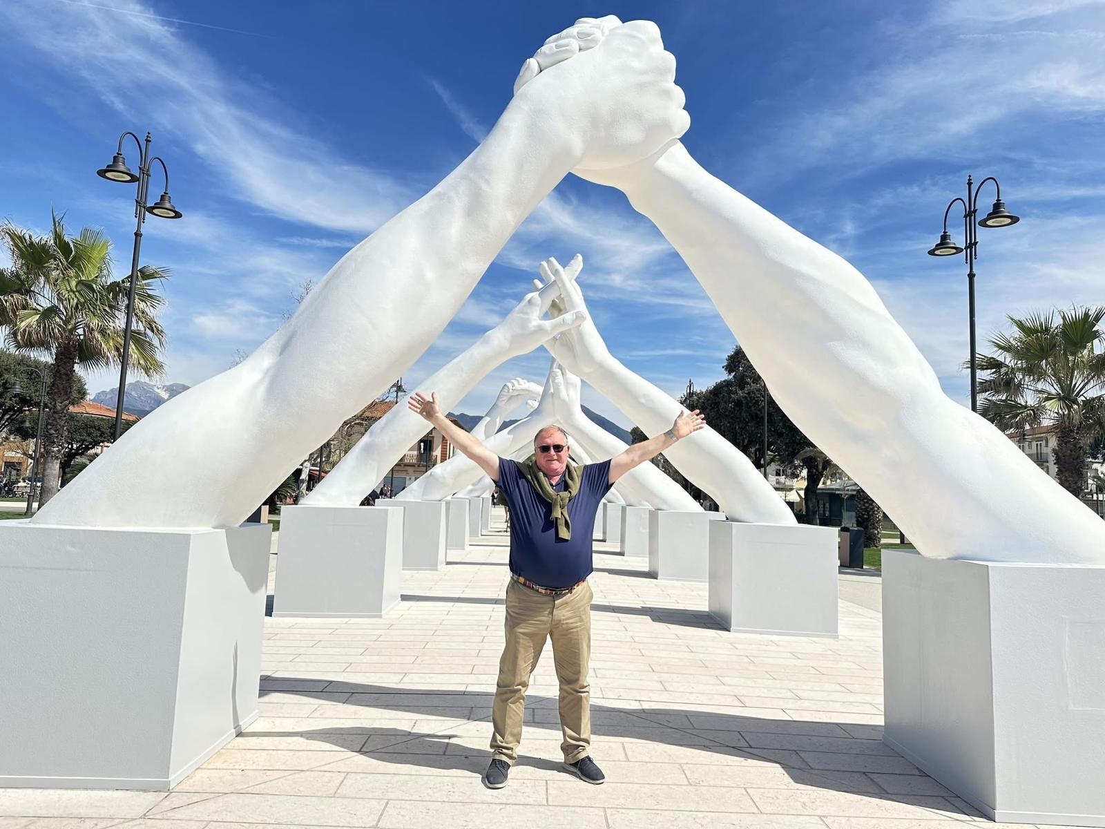 devon delivery services owner under a fine art statue